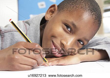 Schoolboy Studying In Classroom View Large Photo Image Stock Image - Schoolboy Studying In Classroom. Fotosearch