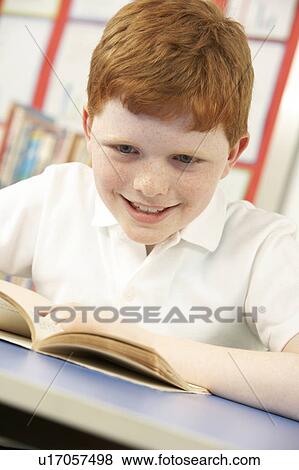 Schoolboy Studying In Classroom View Large Photo Image Stock Photo - Schoolboy Studying In Classroom. Fotosearch