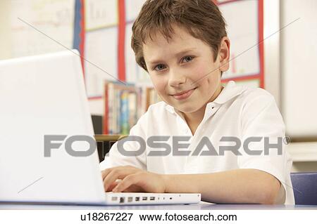 Stock Photo - Schoolboy Studying In Classroom. Fotosearch