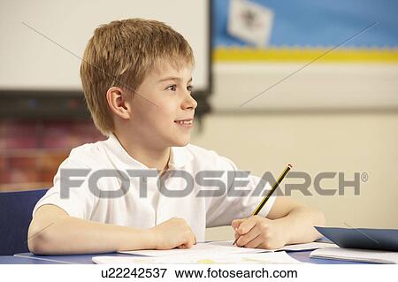 Stock Photo - Schoolboy Studying In Classroom. Fotosearch