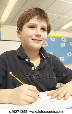 Schoolboy Studying In Classroom View Large Photo Image Stock Photography - Schoolboy Studying In Classroom. Fotosearch