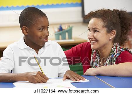 Schoolboy Studying In Classroom With Teacher View Large Photo Image Picture - Schoolboy Studying In Classroom With Teacher. Fotosearch