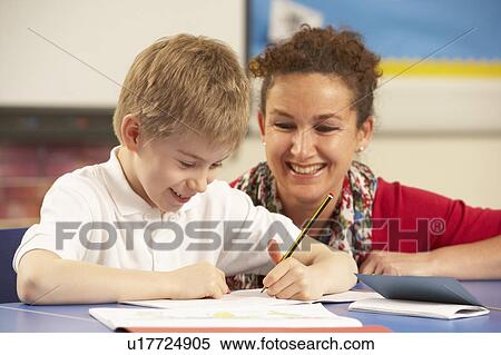 Schoolboy Studying In Classroom With Teacher View Large Photo Image Stock Photography - Schoolboy Studying In Classroom With Teacher. Fotosearch