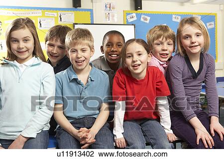 Stock Image - Schoolchildren In classroom. Fotosearch