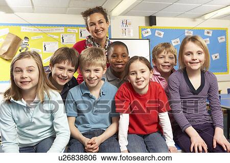 Schoolchildren In classroom with teacher View Large Photo Image Stock Photograph - Schoolchildren In classroom with teacher. Fotosearch
