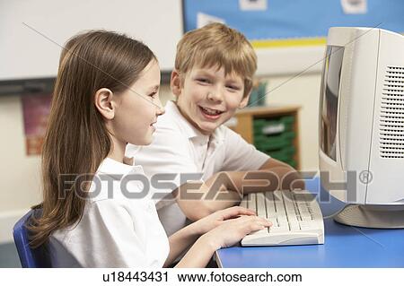 Stock Image - Schoolchildren In IT Class Using Computer. Fotosearch