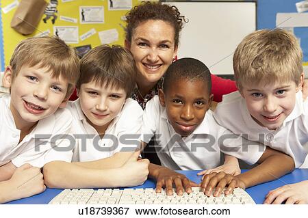Schoolchildren in IT Class Using Computers with teacher View Large Photo Image Stock Photo - Schoolchildren in IT Class Using Computers with teacher. Fotosearch
