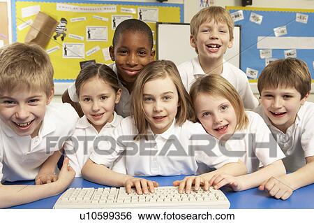 Stock Photograph - Schoolchildren in IT Class Using Computers. Fotosearch