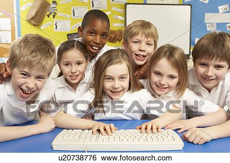 Stock Photograph - Schoolchildren in IT Class Using Computers. Fotosearch
