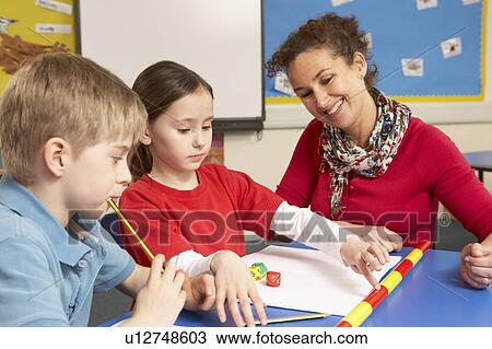 Schoolchildren Studying in classroom with teacher View Large Photo Image Stock Image - Schoolchildren Studying in classroom with teacher. Fotosearch