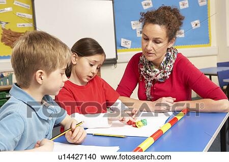 Schoolchildren Studying in classroom with teacher View Large Photo Image Stock Image - Schoolchildren Studying in classroom with teacher. Fotosearch