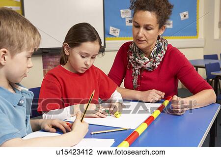 Schoolchildren Studying in classroom with teacher View Large Photo Image Stock Image - Schoolchildren Studying in classroom with teacher. Fotosearch