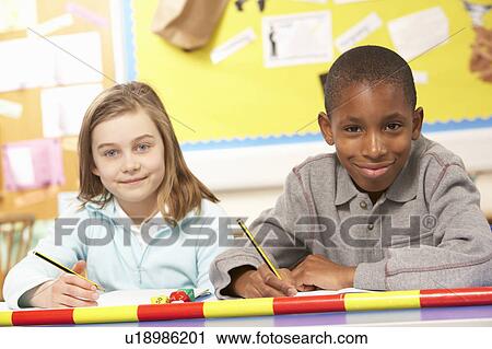 Schoolchildren Studying in classroom View Large Photo Image Stock Image - Schoolchildren Studying in classroom. Fotosearch