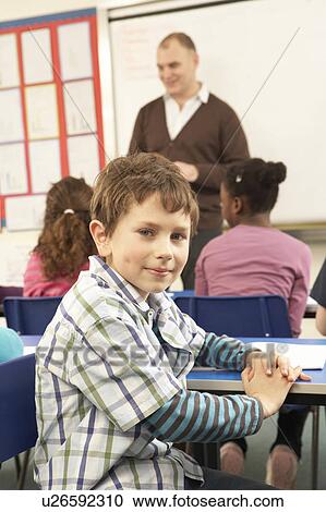 Schoolchildren Studying In Classroom With Teacher View Large Photo Image Stock Image - Schoolchildren Studying In Classroom With Teacher. Fotosearch