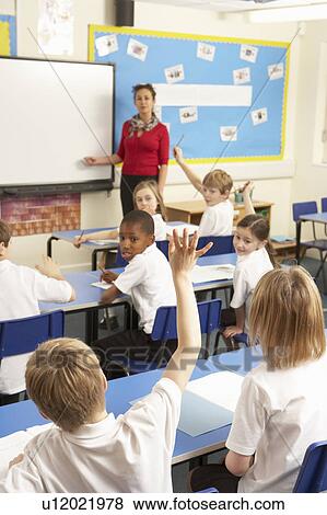 Schoolchildren Studying In Classroom With Teacher View Large Photo Image Stock Photo - Schoolchildren Studying In Classroom With Teacher. Fotosearch