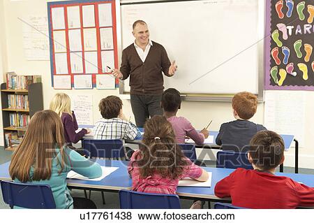 Schoolchildren Studying In Classroom With Teacher View Large Photo Image Stock Photo - Schoolchildren Studying In Classroom With Teacher. Fotosearch