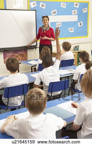 Schoolchildren Studying In Classroom With Teacher View Large Photo Image Stock Photo - Schoolchildren Studying In Classroom With Teacher. Fotosearch