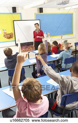 Schoolchildren Studying In Classroom With Teacher View Large Photo Image Stock Photography - Schoolchildren Studying In Classroom With Teacher. Fotosearch