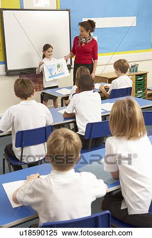 Stock Photography - Schoolchildren Studying In Classroom With Teacher. Fotosearch