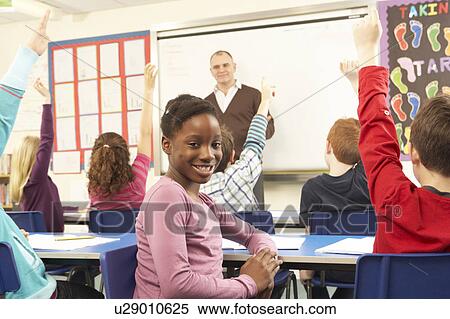 Schoolchildren Studying In Classroom With Teacher View Large Photo Image Stock Photography - Schoolchildren Studying In Classroom With Teacher. Fotosearch