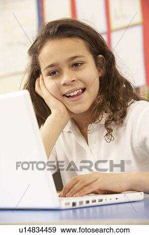 Stock Photo - Schoolgirl In IT Class Using Computer. Fotosearch