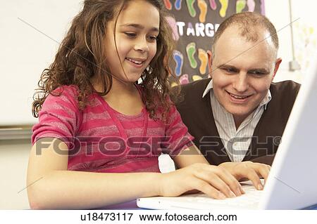 Schoolgirl In IT Class Using Computer With Teacher View Large Photo Image Stock Photo - Schoolgirl In IT Class Using Computer With Teacher. Fotosearch