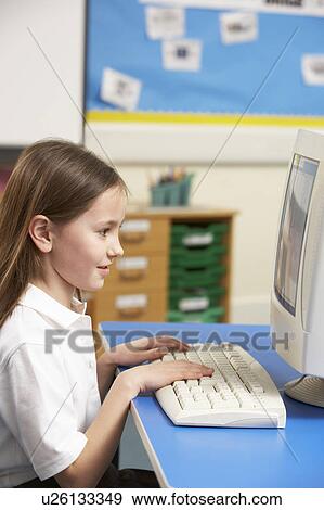 Stock Photo - Schoolgirl In IT Class Using Computer. Fotosearch
