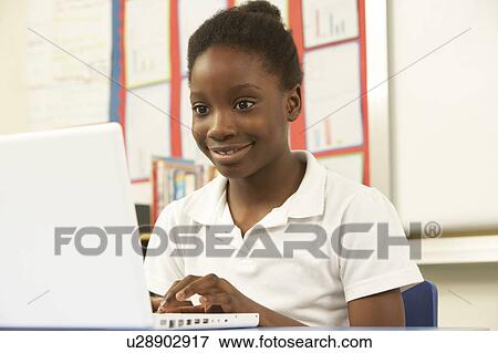 Schoolgirl In IT Class Using Computer View Large Photo Image Stock Photo - Schoolgirl In IT Class Using Computer. Fotosearch