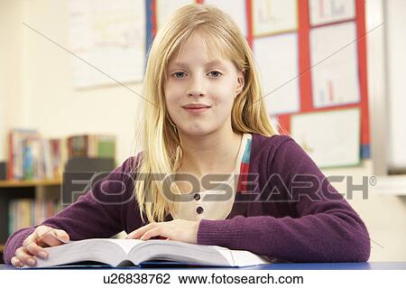 Stock Image - Schoolgirl Studying In Classroom. Fotosearch