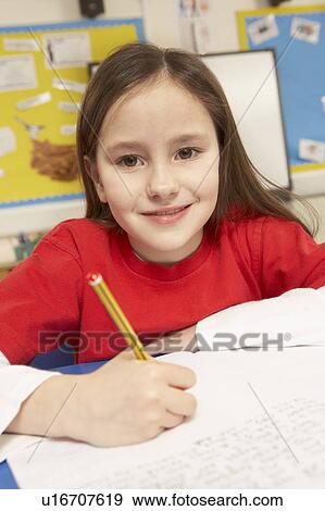 Schoolgirl Studying In Classroom View Large Photo Image Stock Photo - Schoolgirl Studying In Classroom. Fotosearch