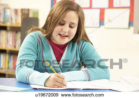 Schoolgirl Studying In Classroom View Large Photo Image Stock Photo - Schoolgirl Studying In Classroom. Fotosearch