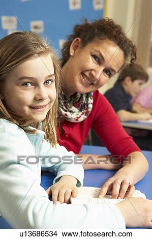 Schoolgirl Studying In Classroom With Teacher View Large Photo Image Picture - Schoolgirl Studying In Classroom With Teacher. Fotosearch