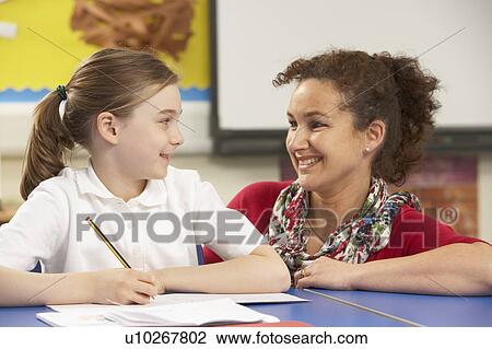 Schoolgirl Studying In Classroom With Teacher View Large Photo Image Stock Image - Schoolgirl Studying In Classroom With Teacher. Fotosearch