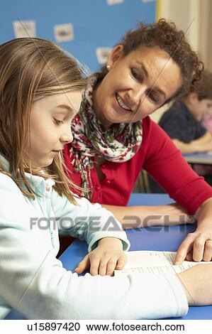Schoolgirl Studying In Classroom With Teacher View Large Photo Image Stock Image - Schoolgirl Studying In Classroom With Teacher. Fotosearch