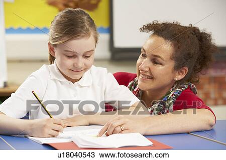 Schoolgirl Studying In Classroom With Teacher View Large Photo Image Stock Image - Schoolgirl Studying In Classroom With Teacher. Fotosearch