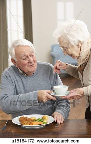 Stock Image - Senior Couple Enjoying Meal Together. Fotosearch