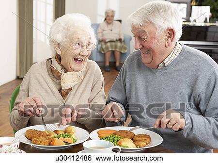 Stock Photograph - Senior Couple Enjoying Meal Together. Fotosearch