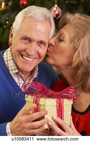 Senior Couple Exchanging Christmas Gifts View Large Photo Image Stock Image - Senior Couple Exchanging Christmas Gifts. Fotosearch