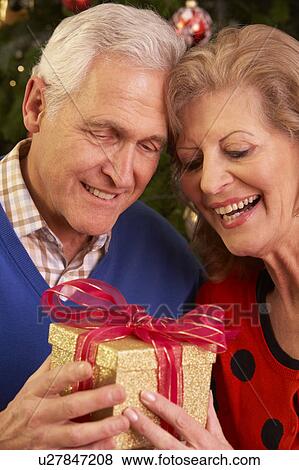 Senior Couple Exchanging Christmas Gifts View Large Photo Image Stock Photo - Senior Couple Exchanging Christmas Gifts. Fotosearch