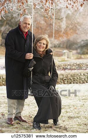 Senior Couple Sitting On Garden Swing In Frosty Landscape View Large Photo Image Stock Image - Senior Couple Sitting On Garden Swing In Frosty Landscape. Fotosearch