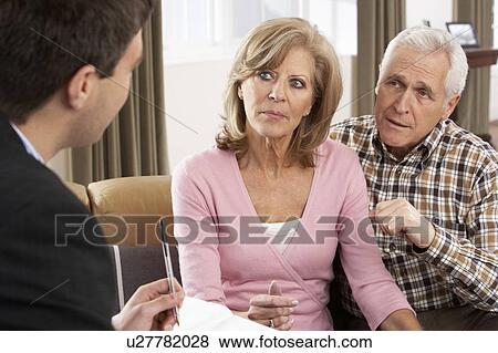 Stock Photo - Senior Couple Talking With Financial Advisor. Fotosearch