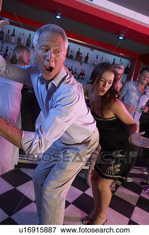 Senior Man Dancing With Younger Woman In Busy Bar View Large Photo Image Stock Photo - Senior Man Dancing With Younger Woman In Busy Bar. Fotosearch