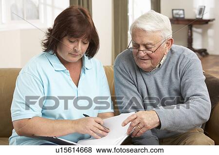 Senior Man In Discussion With Health Visitor At Home View Large Photo Image Stock Photo - Senior Man In Discussion With Health Visitor At Home. Fotosearch