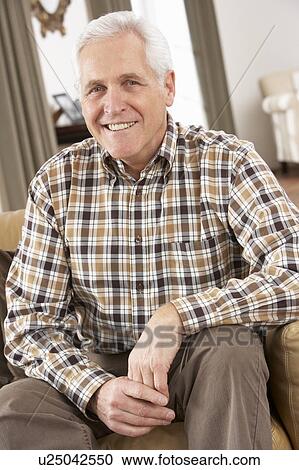 Senior Man Relaxing In Chair At Home View Large Photo Image Stock Image - Senior Man Relaxing In Chair At Home. Fotosearch