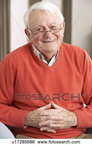 Stock Photo - Senior Man Relaxing In Chair At Home. Fotosearch
