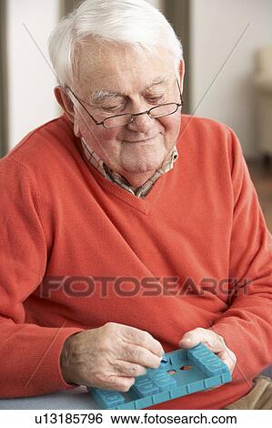 Senior Man Sorting Medication Using Organiser At Home View Large Photo Image Stock Photograph - Senior Man Sorting Medication Using Organiser At Home. Fotosearch