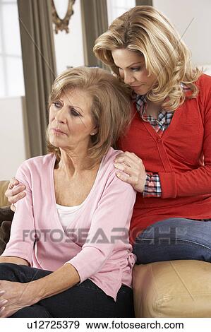 Stock Photo - Senior Woman Being Consoled By Adult Daughter. Fotosearch
