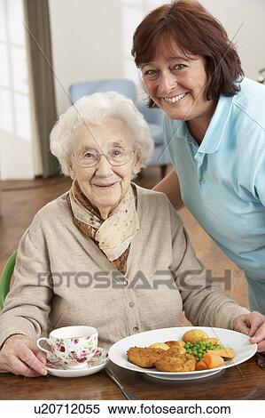 Senior Woman Being Served Meal By Carer View Large Photo Image Stock Photography - Senior Woman Being Served Meal By Carer. Fotosearch