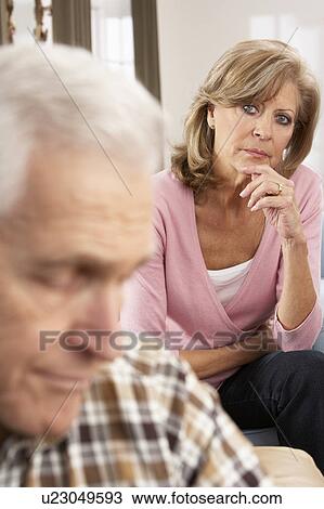 Stock Image - Senior Woman Caring For Sick Husband. Fotosearch