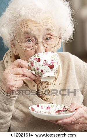 Senior Woman Enjoying Cup Of Tea At Home View Large Photo Image Picture - Senior Woman Enjoying Cup Of Tea At Home. Fotosearch